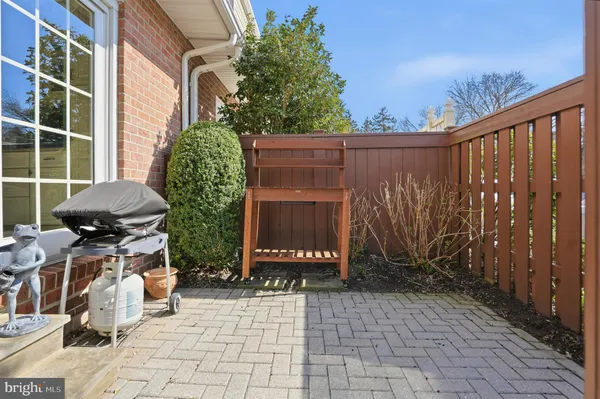 a view of a pathway with a bench in patio