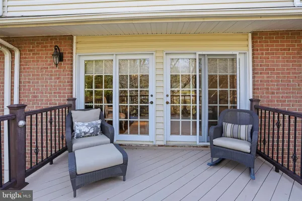 a balcony with furniture and wooden floor