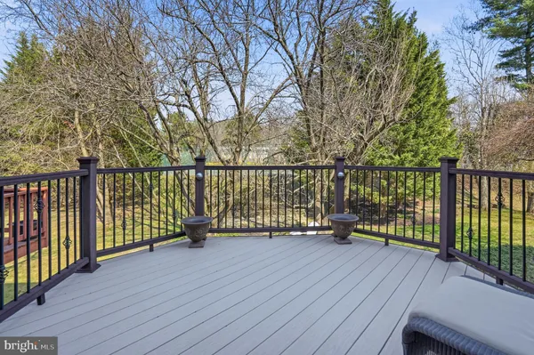 a view of balcony with wooden floor and fence