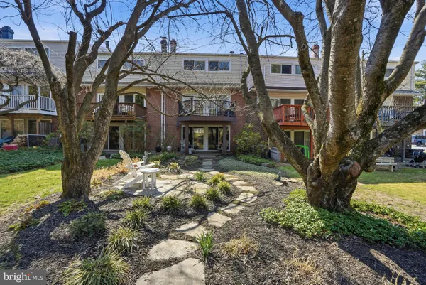 a view of a house with a yard and tree s