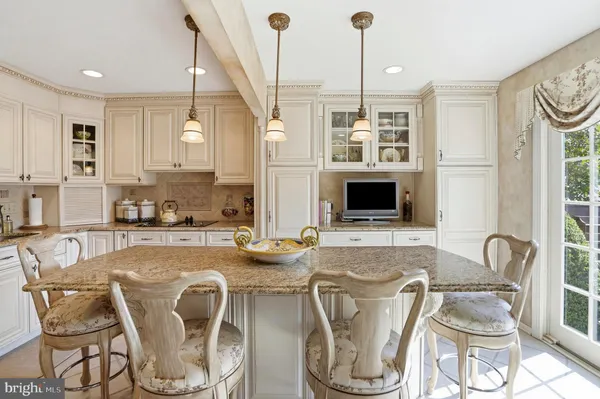 a dining room with furniture a window and kitchen view