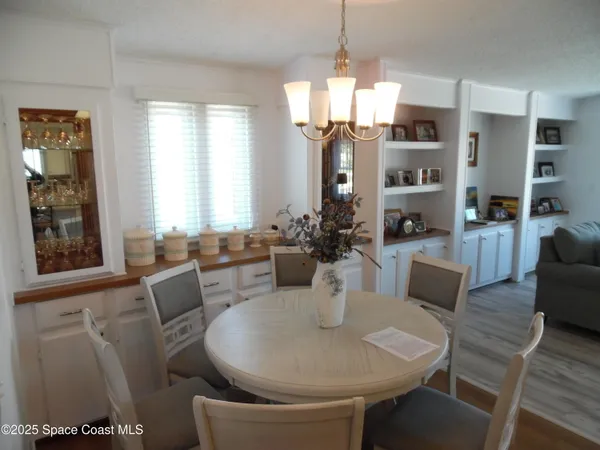 a living room with furniture a large window and a table