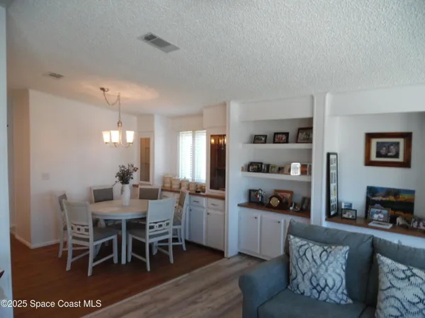 a living room with furniture a dining table and a fireplace