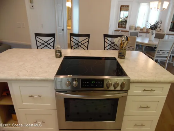 a stove top oven sitting inside of a kitchen