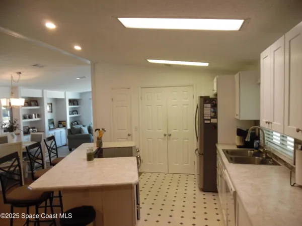 a large kitchen with a table and chairs