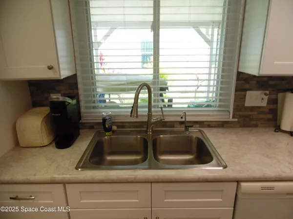a kitchen with a sink and a window
