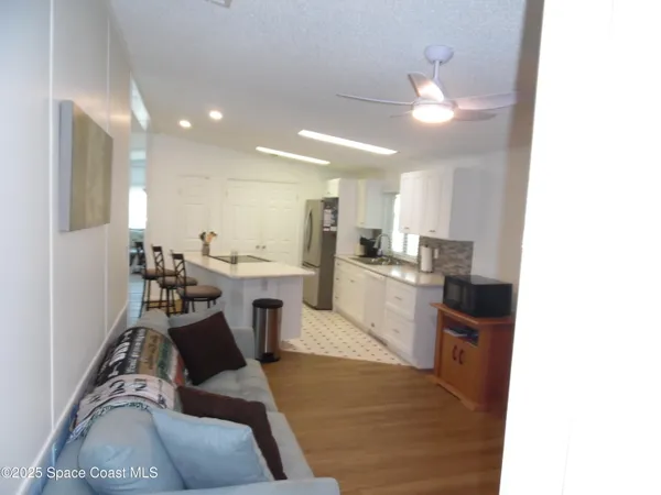 a view of kitchen with cabinets and wooden floor