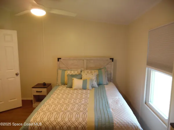 a bedroom with a bed and window