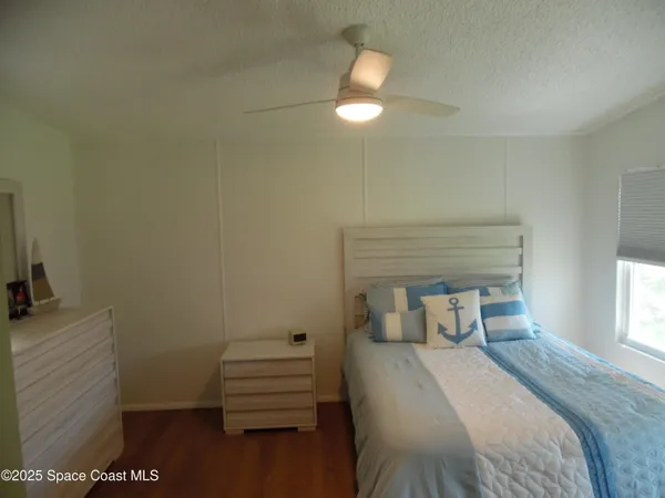 a bedroom with a bed and a night stand