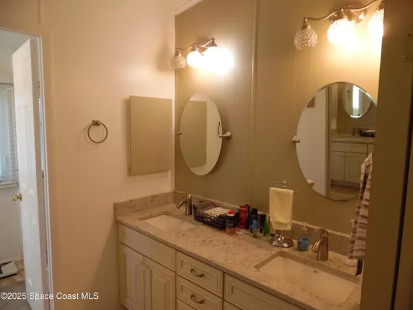 a bathroom with a double vanity sink and a mirror