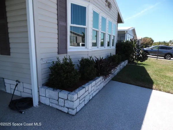 a view of a street with potted plants