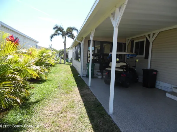 a hallway with a dining table and a chandelier