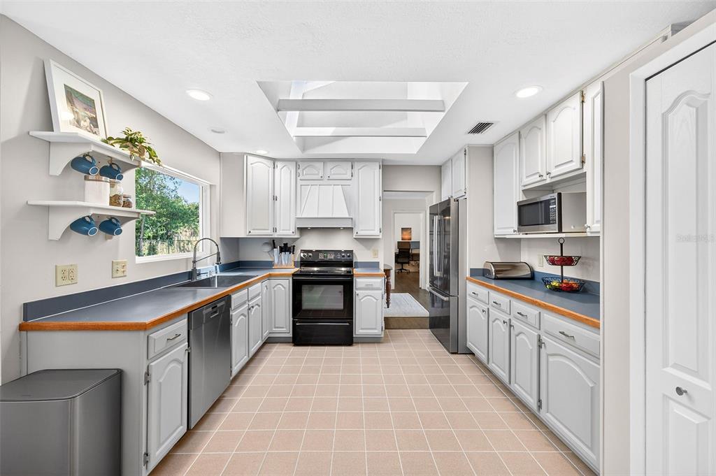 517 Roughbeard Road Winter Park, FL 32792 - Photo 13 of 53 a kitchen with stainless steel appliances granite countertop a refrigerator and a stove