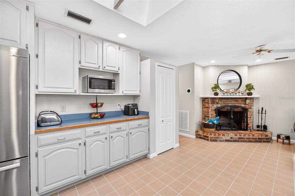 517 Roughbeard Road Winter Park, FL 32792 - Photo 14 of 53 a kitchen with white cabinets and a fireplace