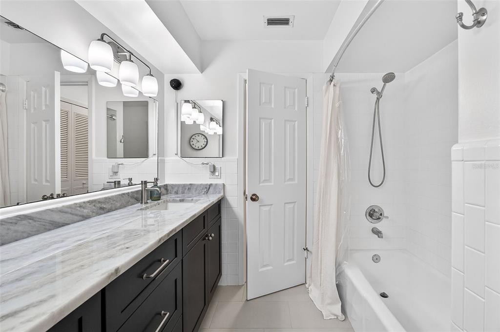 517 Roughbeard Road Winter Park, FL 32792 - Photo 18 of 53 a bathroom with a granite countertop sink a toilet and shower