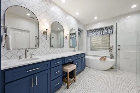 a spacious bathroom with a double vanity sink mirror double and bathtub