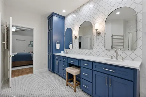 a bathroom with a double vanity sink and a mirror