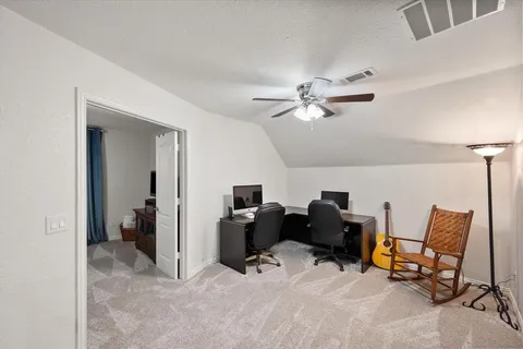 a view of workspace with furniture and a ceiling fan