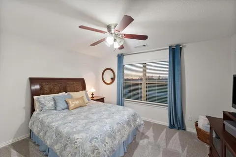 a bedroom with a large bed and a large window