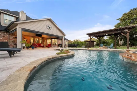 a view of swimming pool with outdoor seating and wooden floor