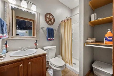 a bathroom with a toilet sink and mirror