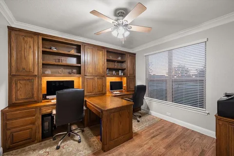 a workspace with furniture window and wooden floor