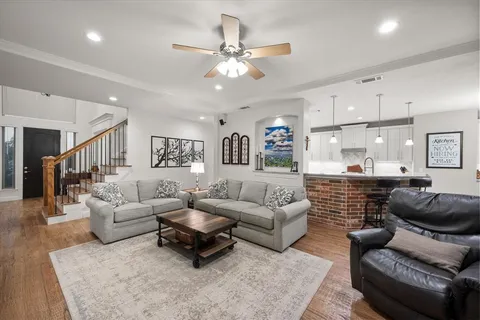 a living room with furniture and a ceiling fan