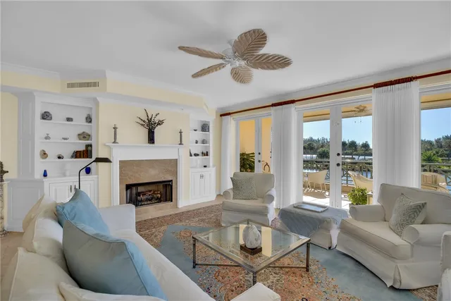 a view of a hallway to a livingroom with furniture