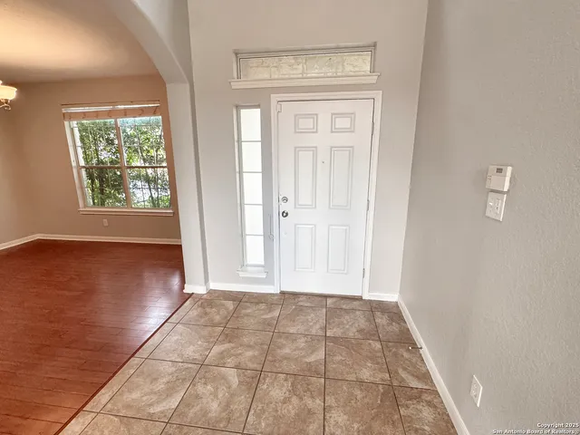 a view of an empty room with windows