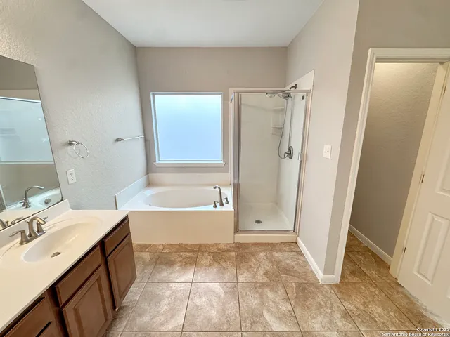a bathroom with a sink a mirror and a bathtub