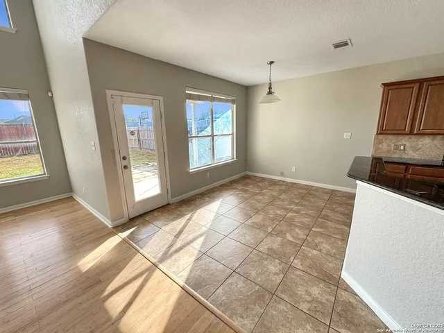 a view of a kitchen with wooden floor and a sink