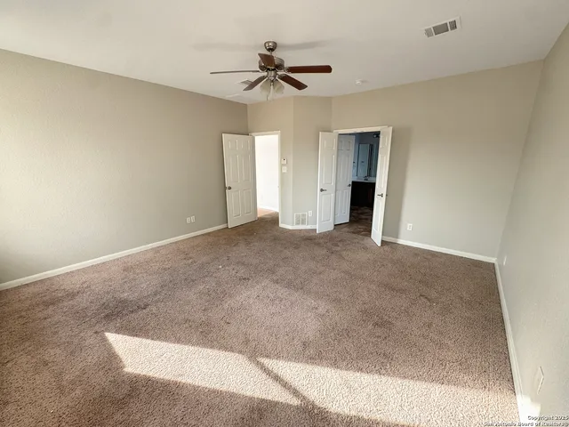 a view of a livingroom with a ceiling fan and entryway