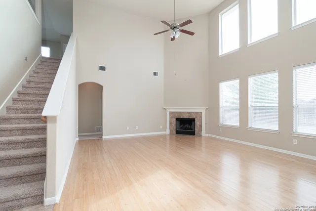 wooden floor in an empty room with a fireplace