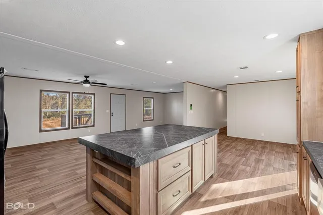 a kitchen with granite countertop a sink and a stove top oven