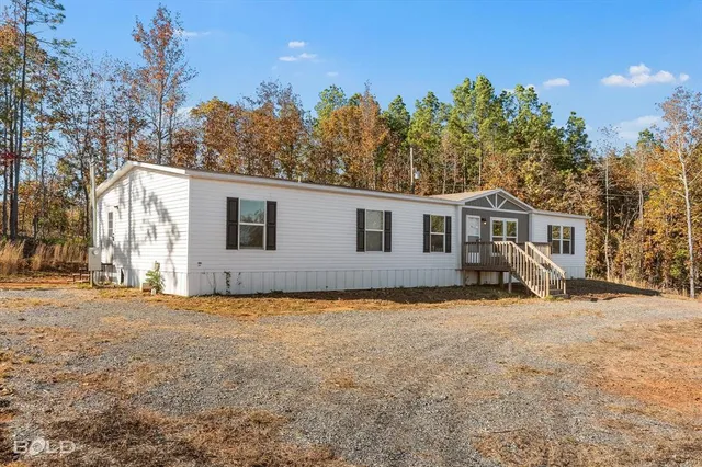 a view of a house with a yard and deck