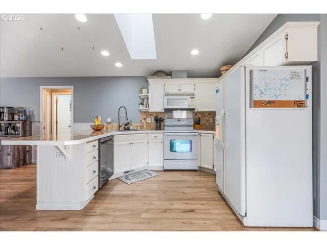 a kitchen with stainless steel appliances sink refrigerator and microwave
