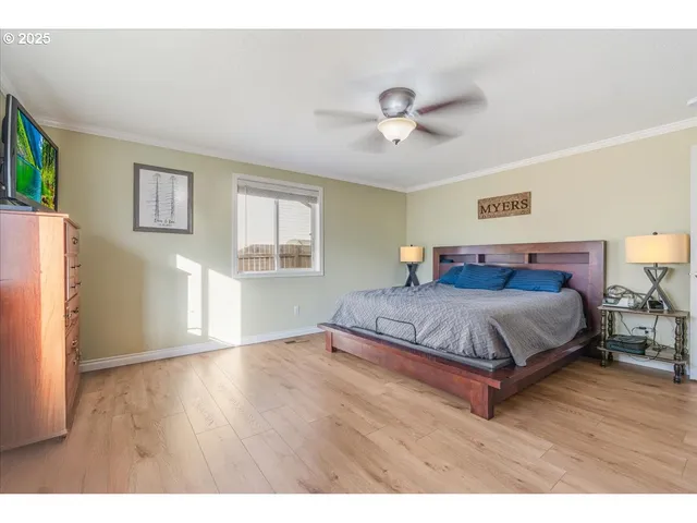 a bedroom with a large bed and a chandelier