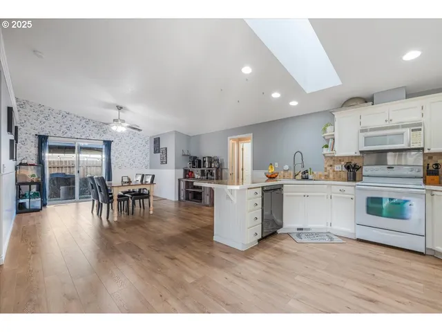 a kitchen with furniture and wooden floors