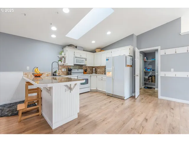 a open kitchen with stainless steel appliances kitchen island a refrigerator sink and cabinets