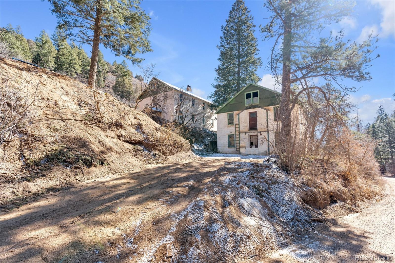 1906 Hidden Valley Road Sedalia, CO 80135 - Photo 11 of 27 a backyard of a house with large trees