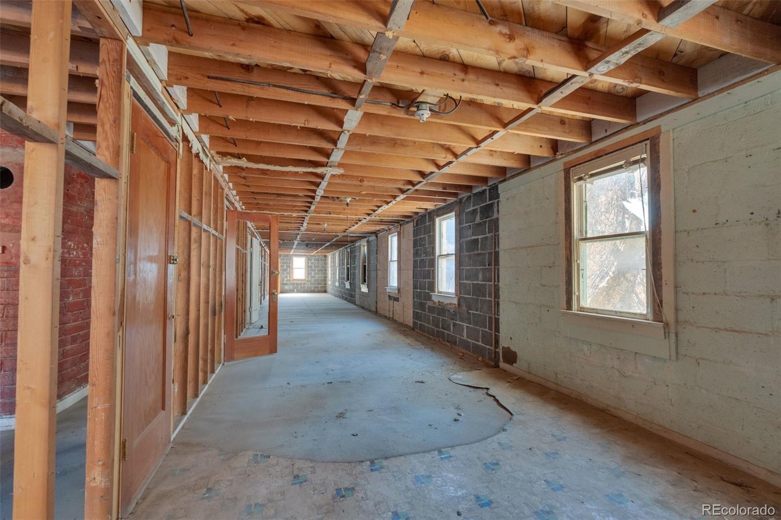 1906 Hidden Valley Road Sedalia, CO 80135 - Photo 13 of 27 a view of a room with wooden walls
