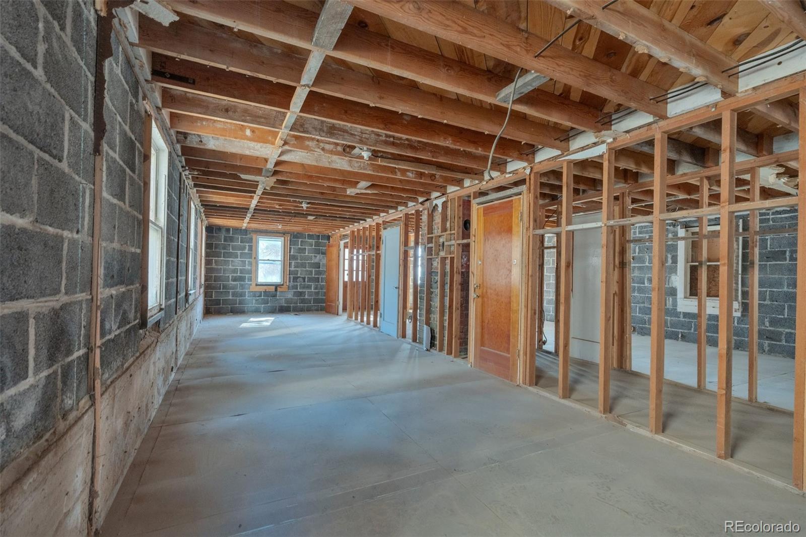 1906 Hidden Valley Road Sedalia, CO 80135 - Photo 15 of 27 a view of empty room with wooden walls