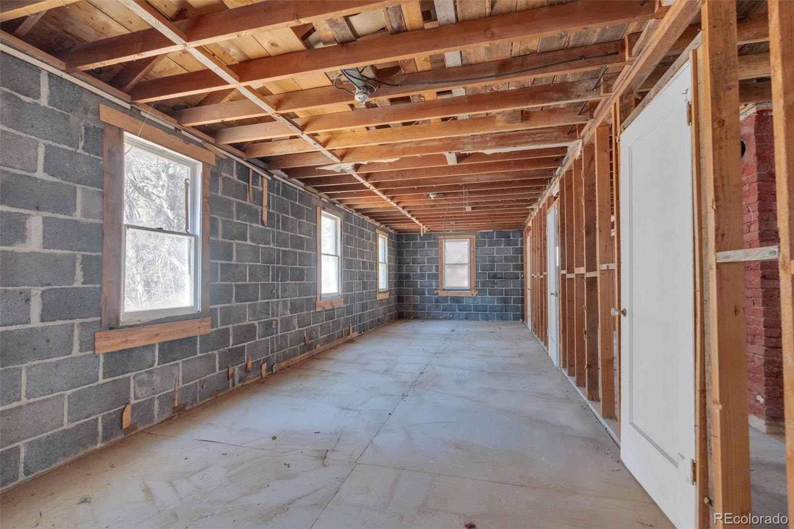 1906 Hidden Valley Road Sedalia, CO 80135 - Photo 17 of 27 a view of empty room with windows