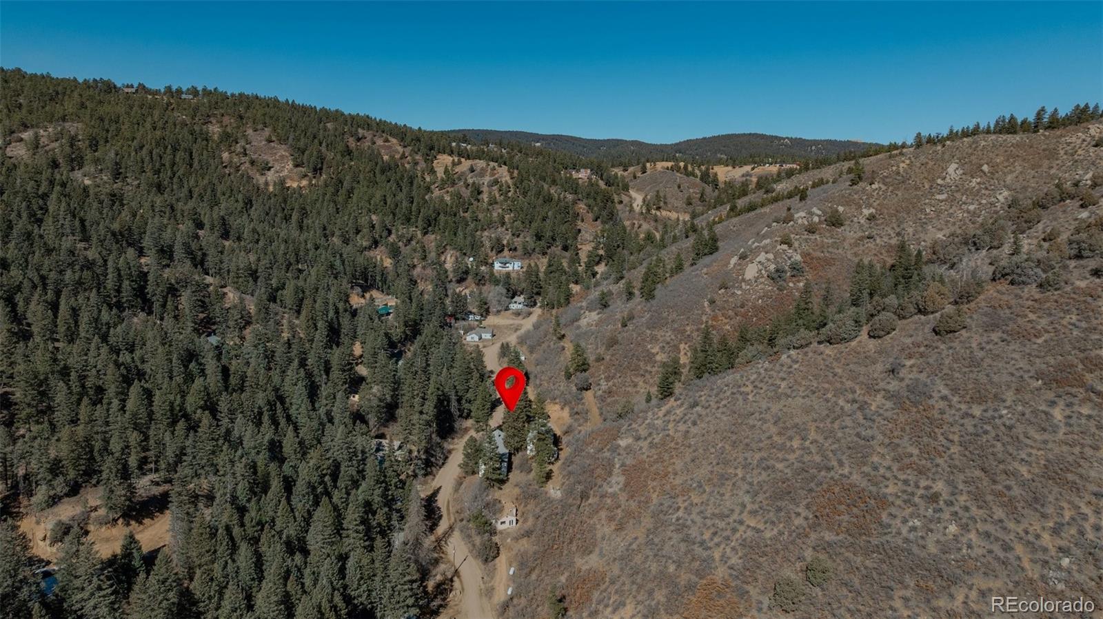 1906 Hidden Valley Road Sedalia, CO 80135 - Photo 19 of 27 a view of a yard with a mountain