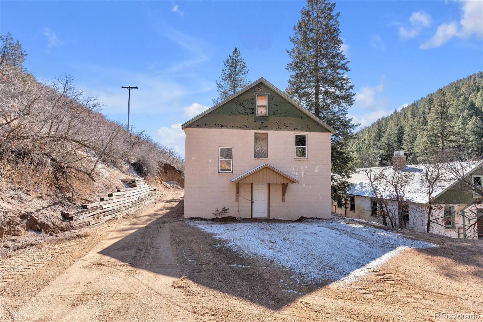 1906 Hidden Valley Road Sedalia, CO 80135 - Photo 2 of 27 a front view of a house with a yard