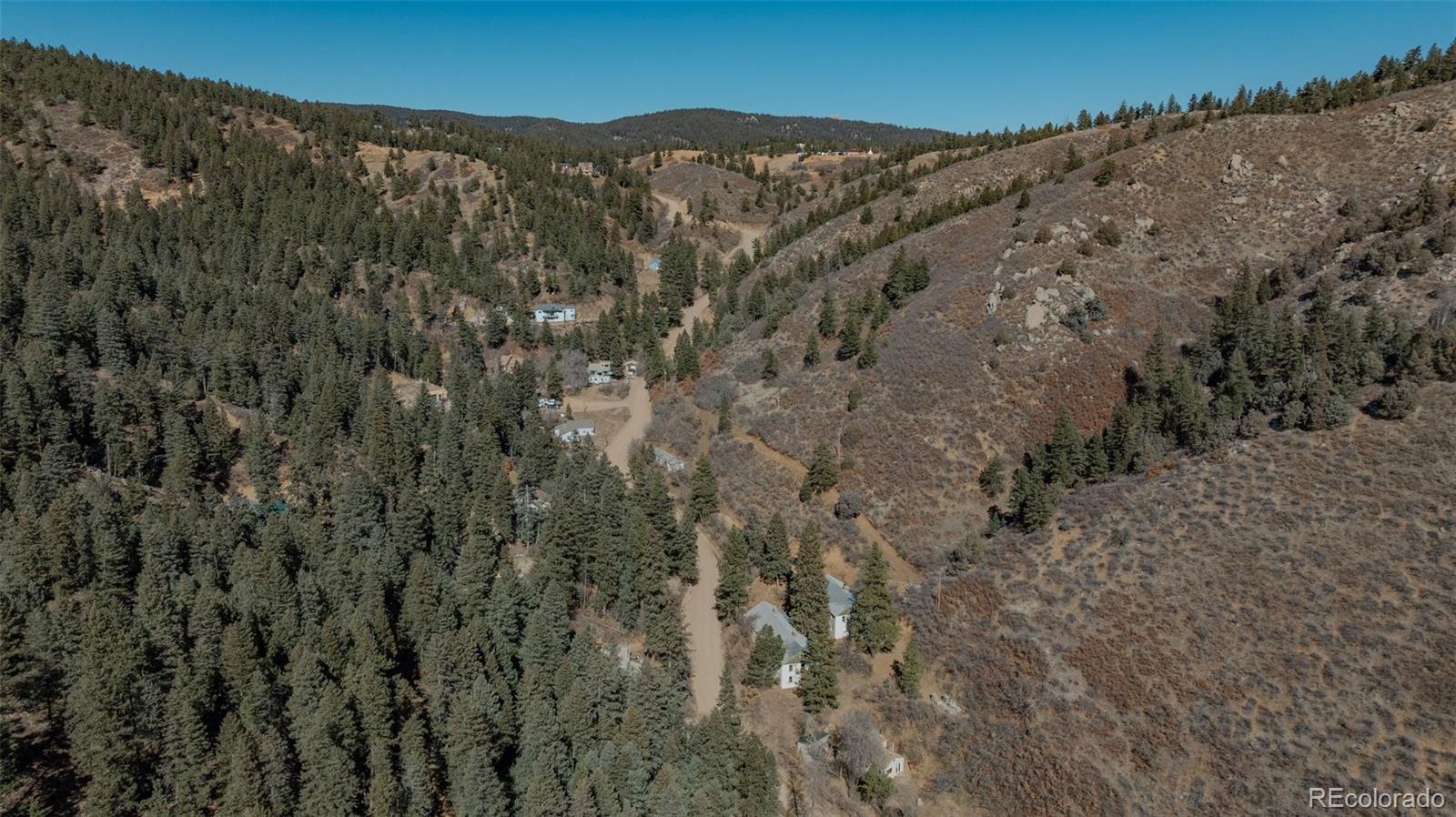 1906 Hidden Valley Road Sedalia, CO 80135 - Photo 23 of 27 a view of a dry yard with mountains in the background