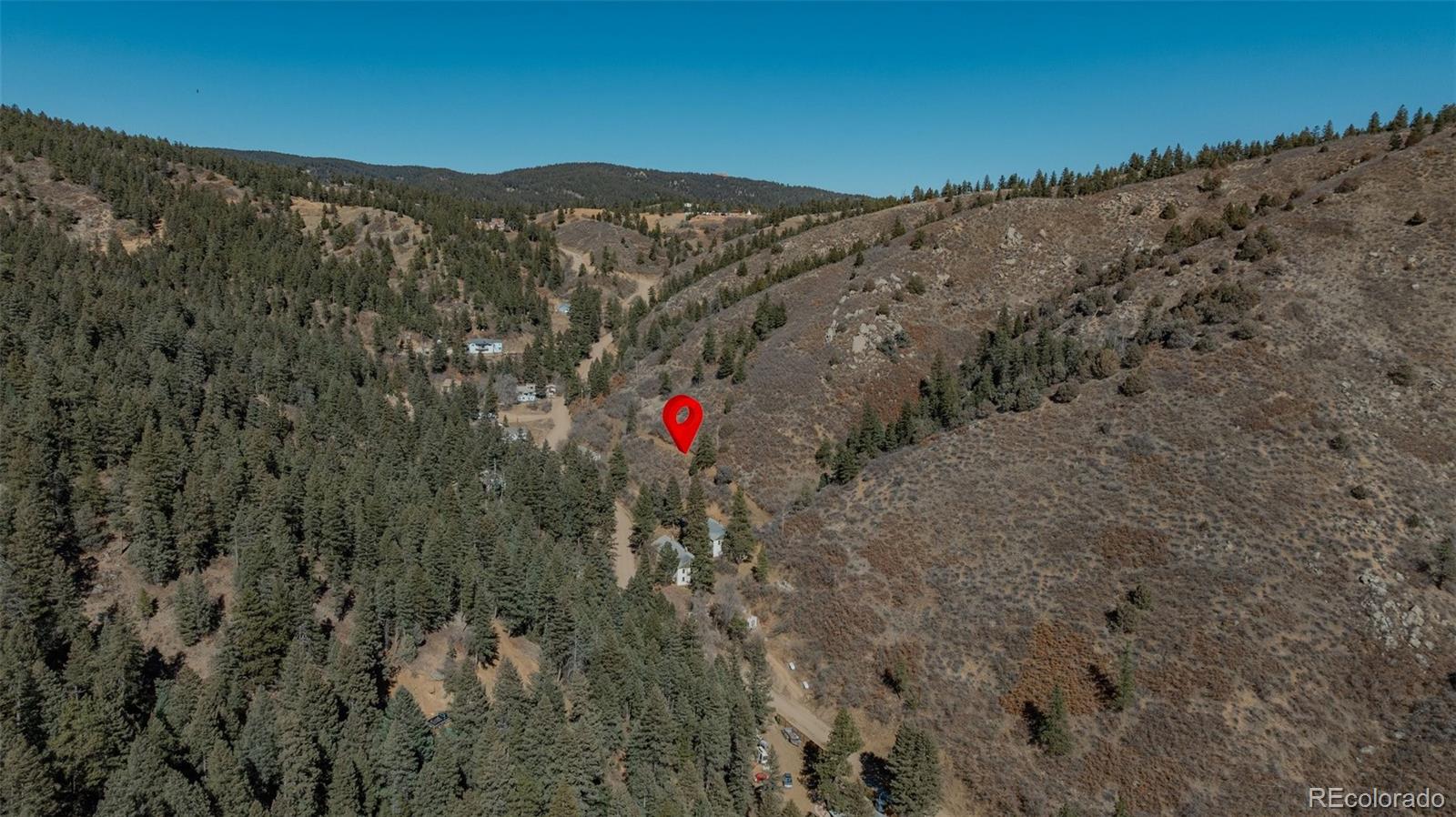 1906 Hidden Valley Road Sedalia, CO 80135 - Photo 25 of 27 a view of a dry yard with mountains in the background