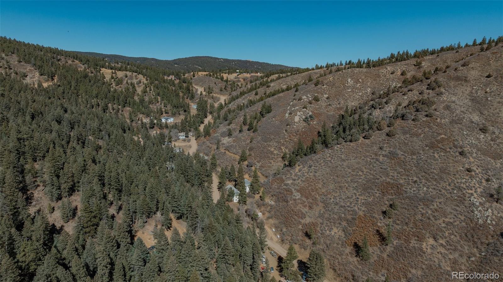 1906 Hidden Valley Road Sedalia, CO 80135 - Photo 26 of 27 a view of a dry yard with mountains in the background