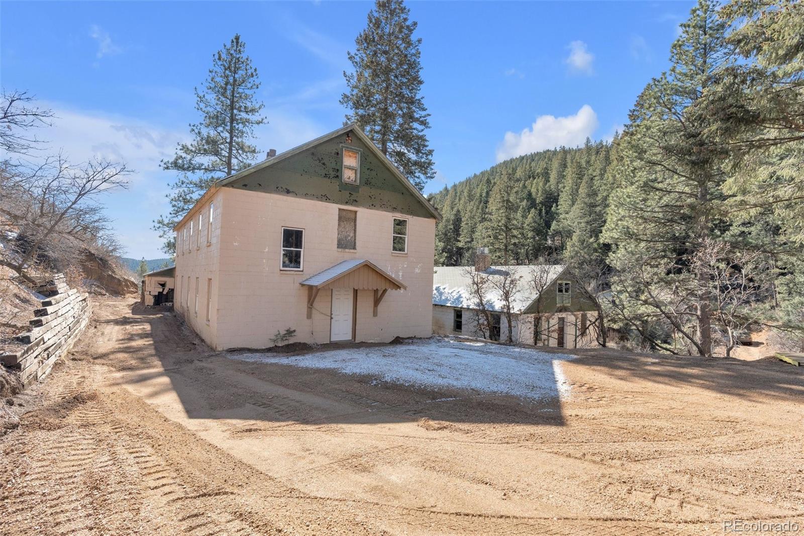 1906 Hidden Valley Road Sedalia, CO 80135 - Photo 3 of 27 a view of a house with a snow in the background