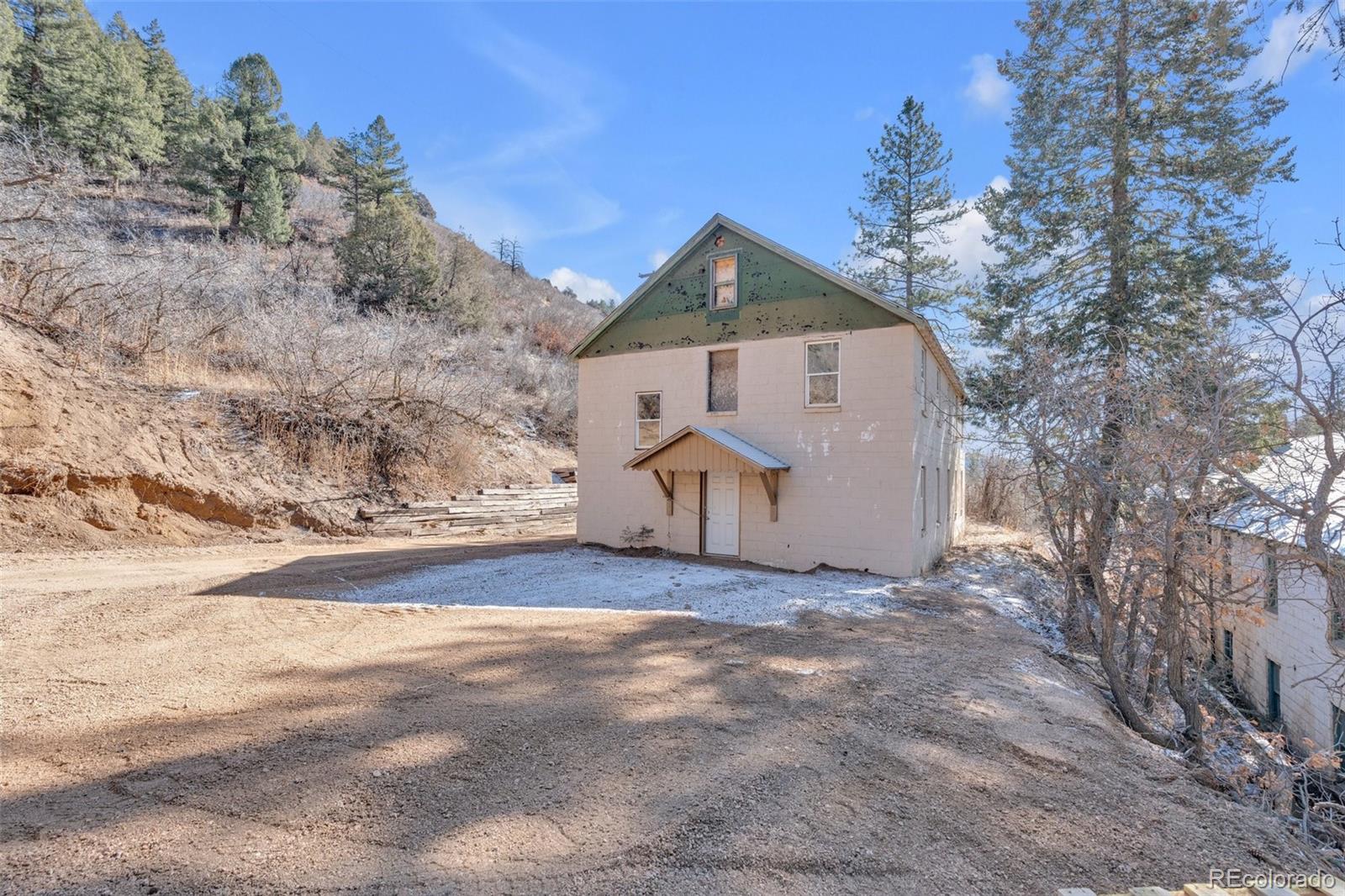 1906 Hidden Valley Road Sedalia, CO 80135 - Photo 4 of 27 a view of a house with a yard
